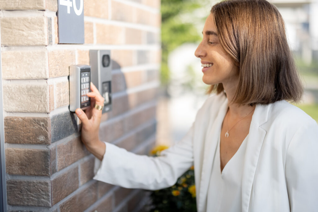Woman entering code on a keyboard to access a door Common Security Vulnerabilities